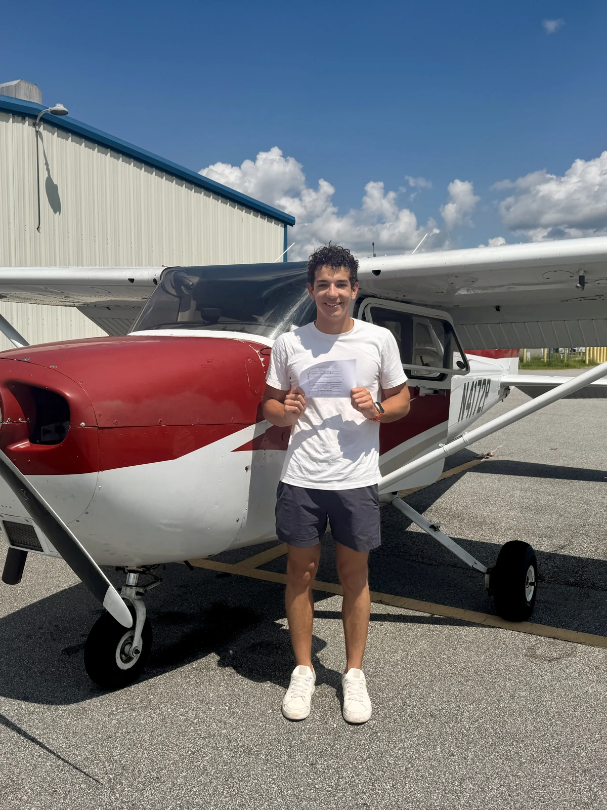 Gabriel standing beside a light aircraft